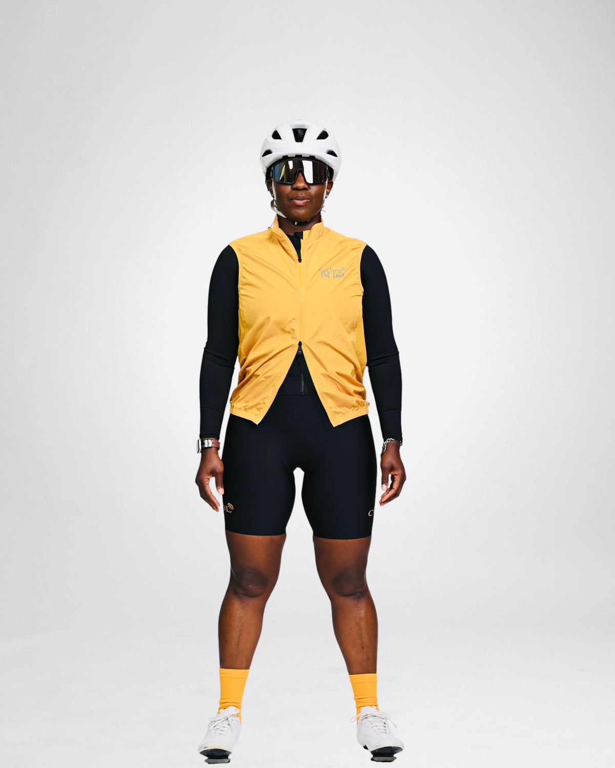 Cycling Out Loud unisex gold cycling vest/gilet, worn on model, side view, women's fit
