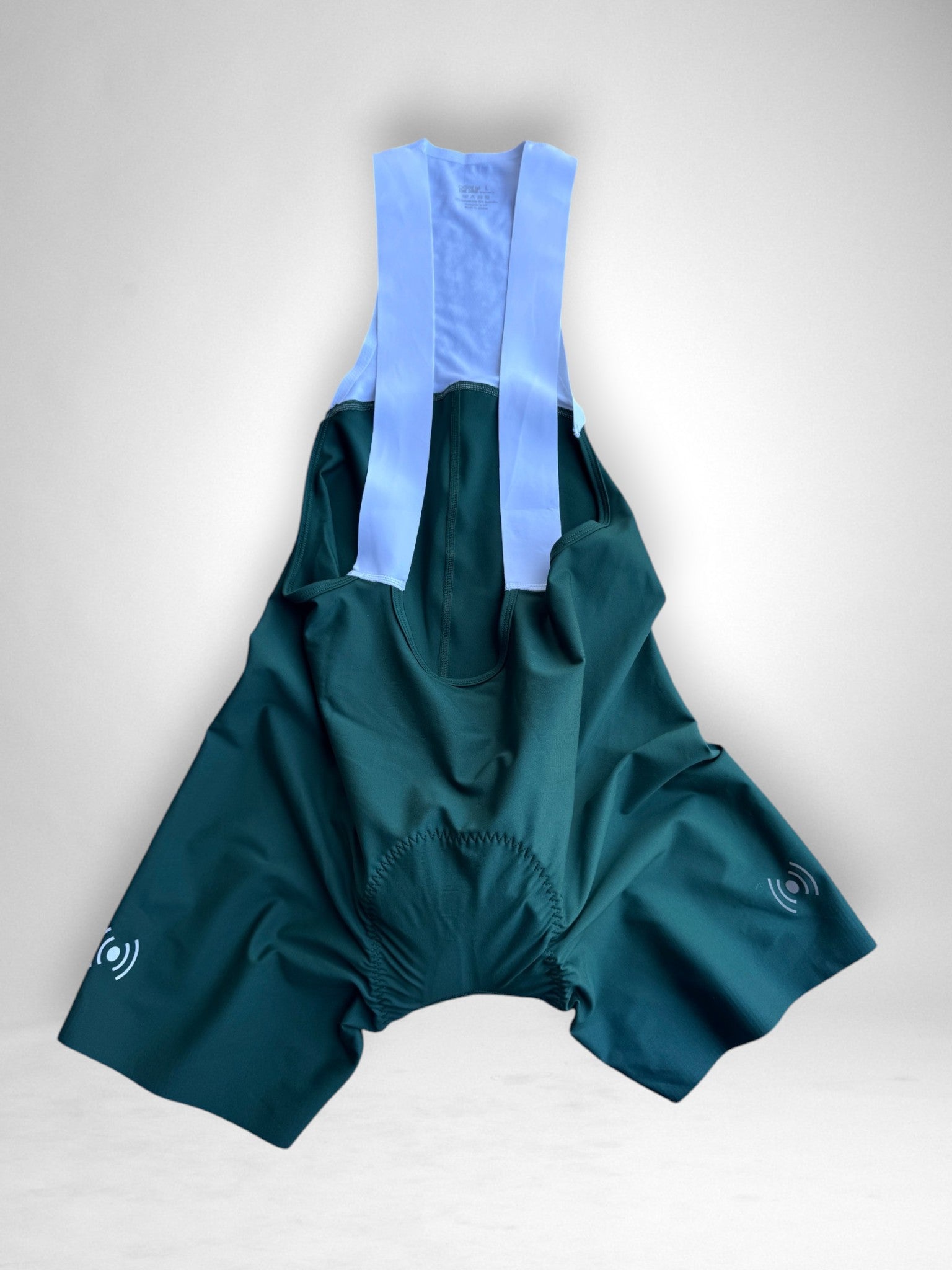 Cycling Out Loud Women's Emerald Green bibs worn on model, side view